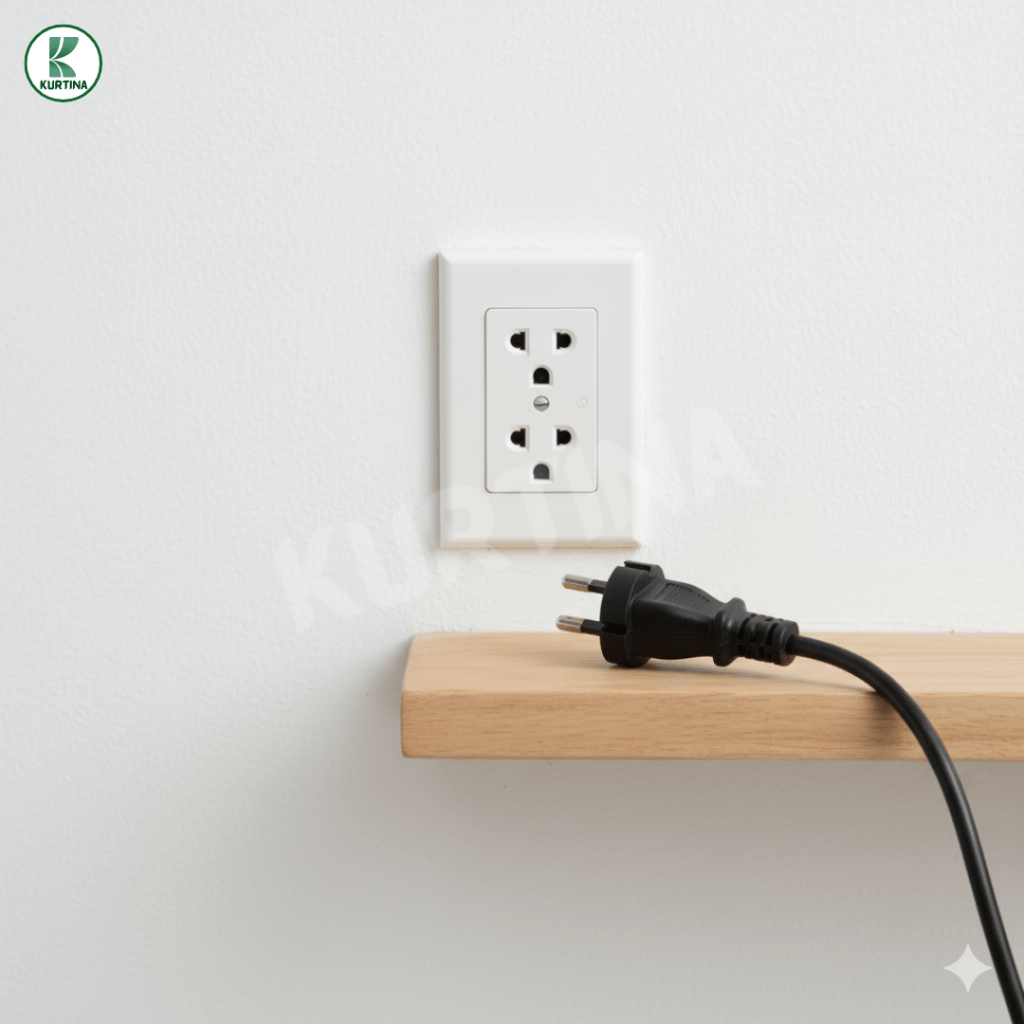 An unplugged power cord resting beside a wall socket, reminding renters to unplug appliances for safety before Undas.